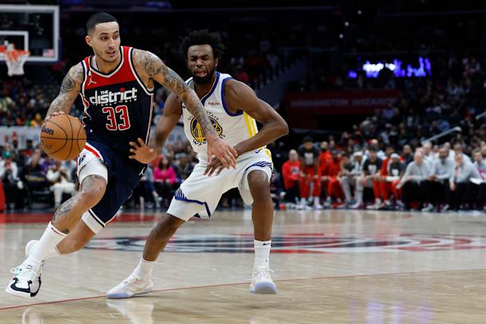Washington Wizards forward Kyle Kuzma (33) drives against a Golden State Warriors defender.